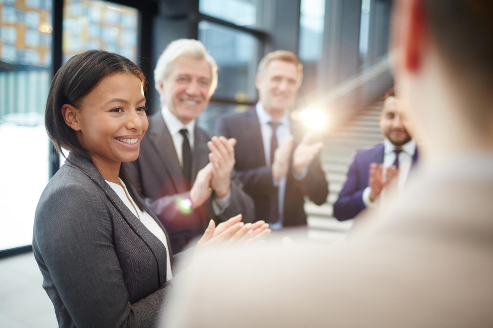 picture of employees congratulating fellow employee.