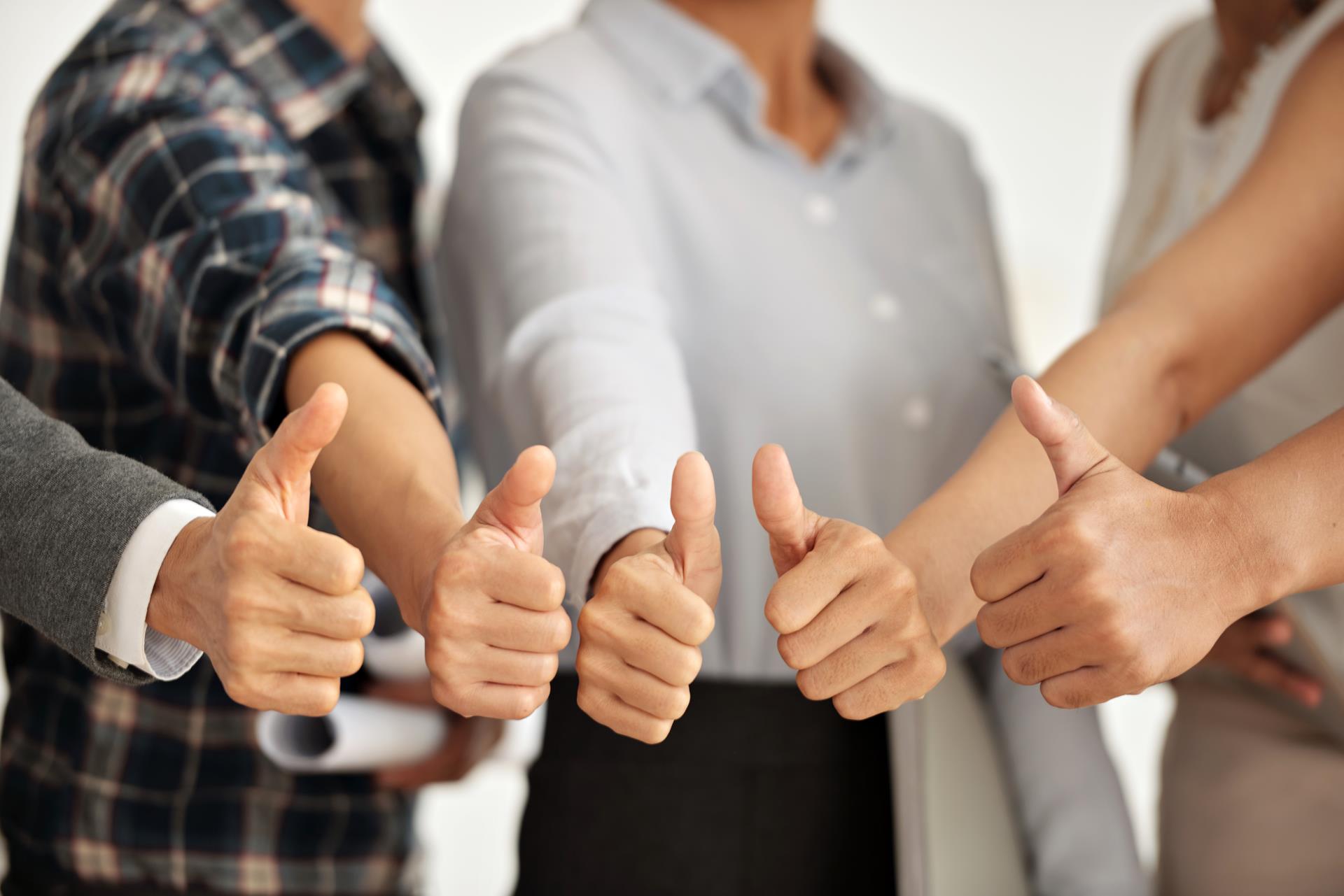 picture of a group showing thumbs up success